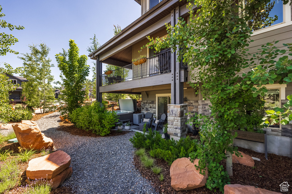 View of yard featuring a balcony and a patio area