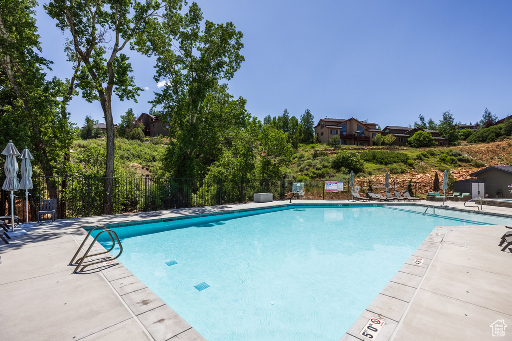 Community pool with a patio