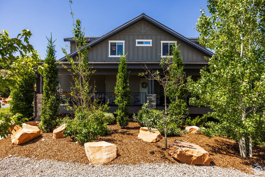 Craftsman inspired home featuring a porch and board and batten siding