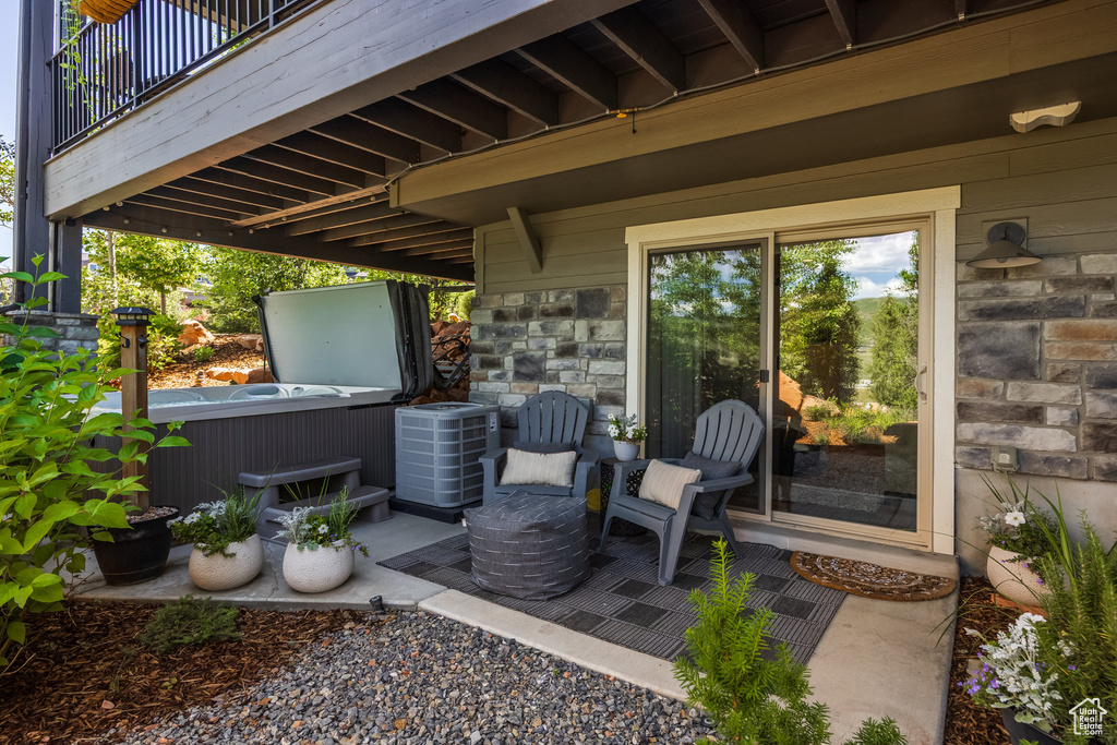 Patio / terrace with a hot tub and a patio area