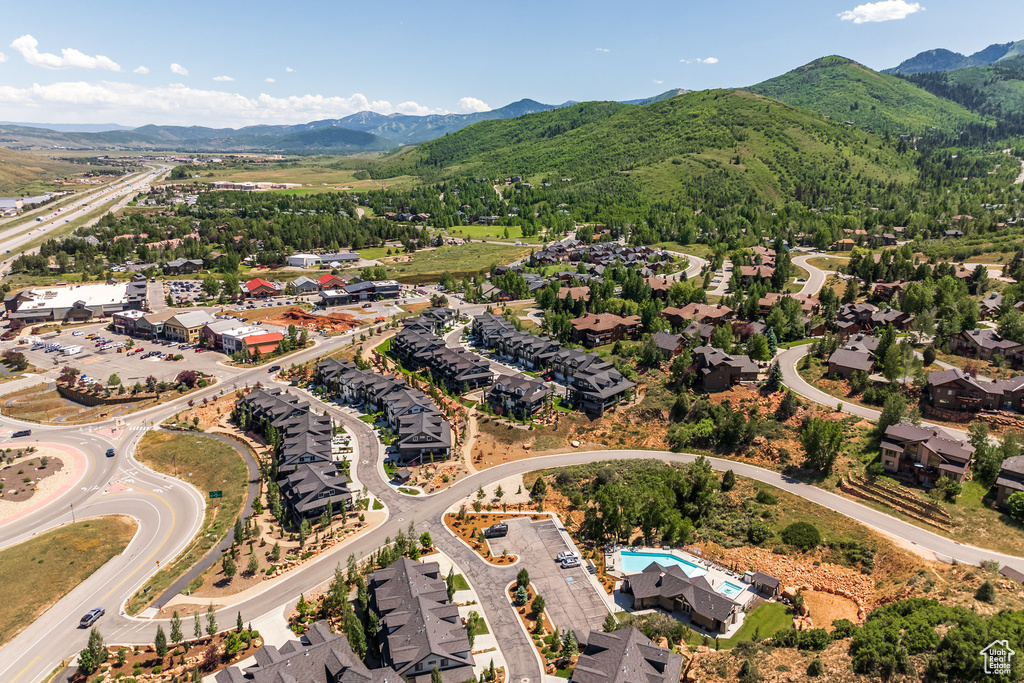 Aerial overview of property's location featuring a mountain backdrop and nearby suburban area
