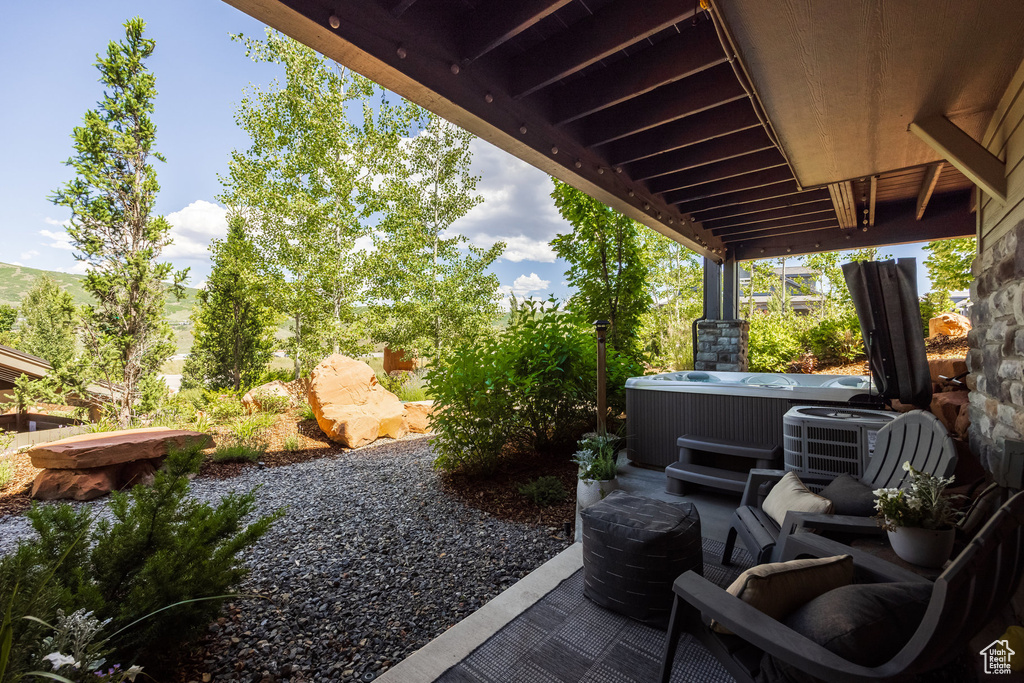 View of patio with a hot tub