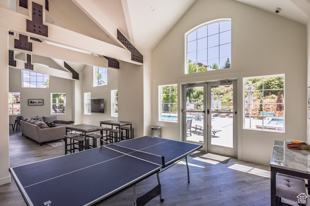 Rec room featuring high vaulted ceiling, wood finished floors, and french doors