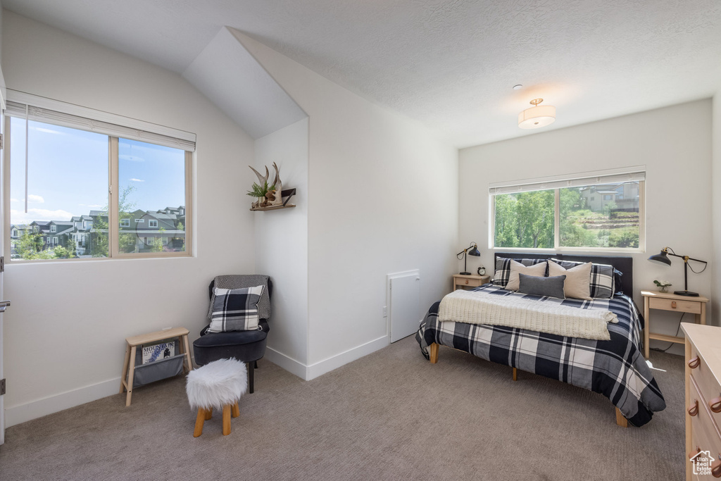 Bedroom featuring light carpet and baseboards