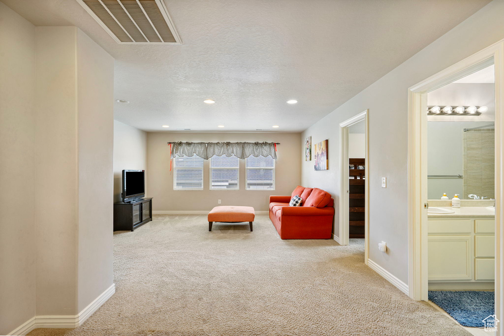 Living area featuring carpet floors and recessed lighting