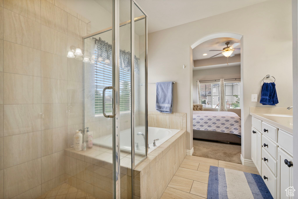 Full bath with a garden tub, a shower stall, vanity, ceiling fan, and ensuite bathroom