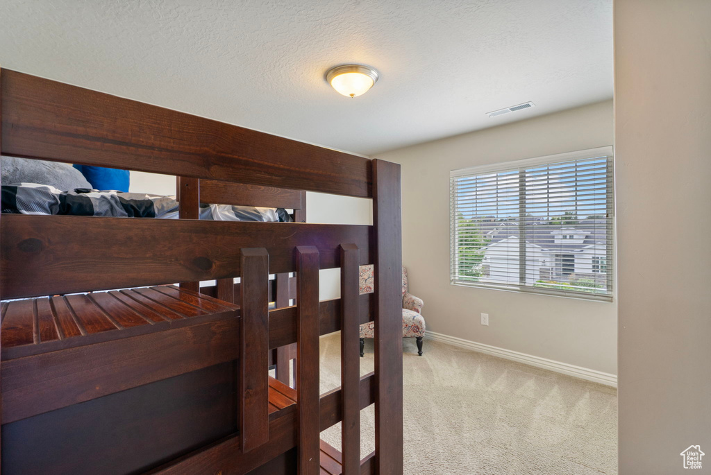 Carpeted bedroom featuring baseboards
