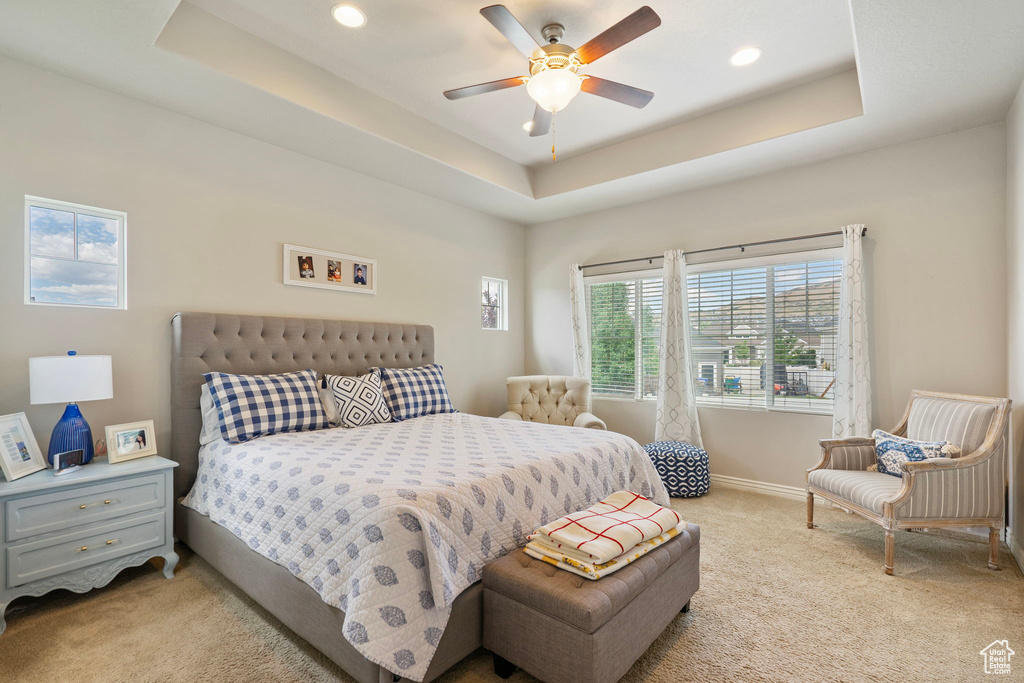 Bedroom featuring carpet floors, a tray ceiling, recessed lighting, and ceiling fan