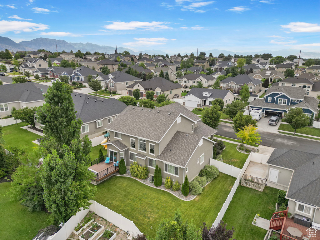 Aerial view of residential area featuring a mountainous background