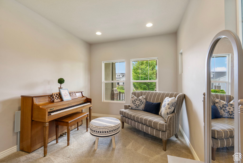 Sitting room featuring plenty of natural light, recessed lighting, and carpet floors