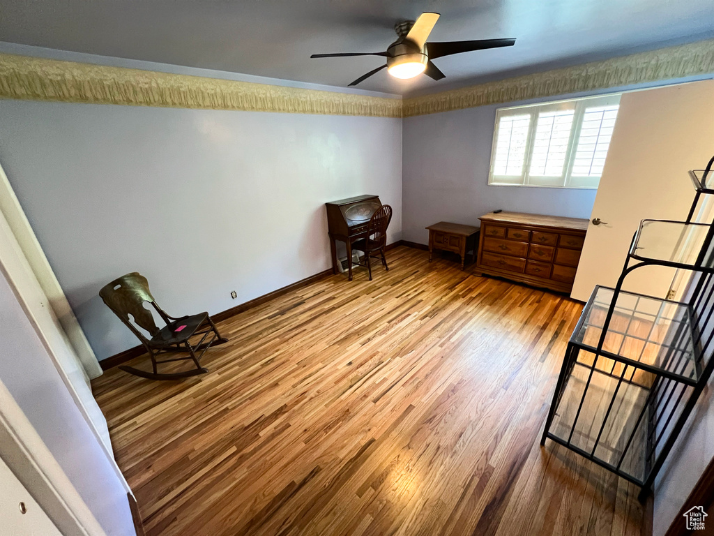 Bedroom with wood finished floors and a ceiling fan