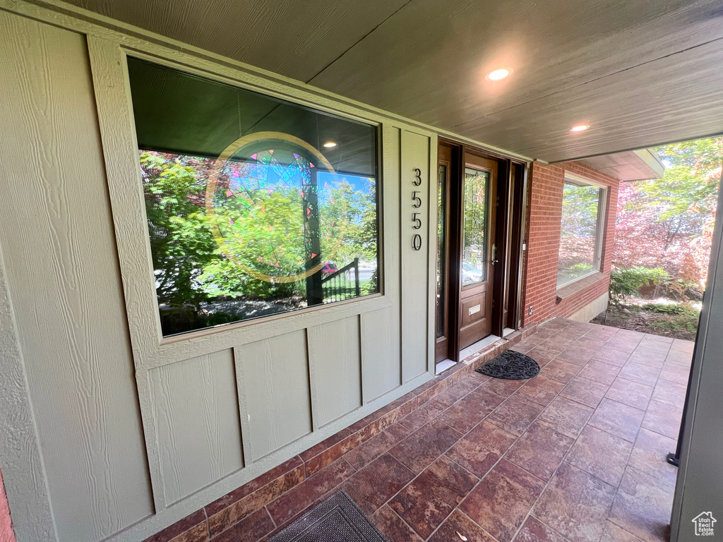 Entrance to property featuring board and batten siding and a porch