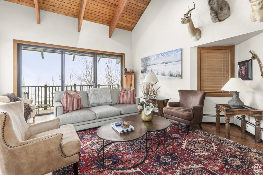 Living area featuring a wood ceiling with exposed beams, wood finished floors, and high vaulted ceiling