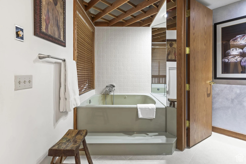 Full bath with a garden tub and tile patterned flooring