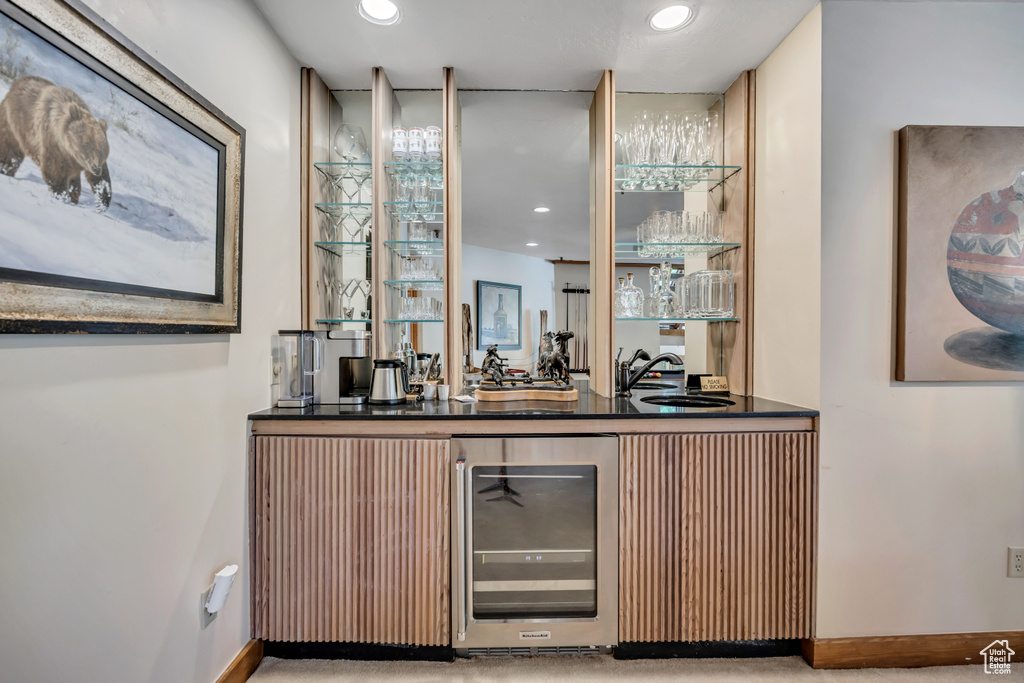Indoor wet bar featuring wine cooler and recessed lighting