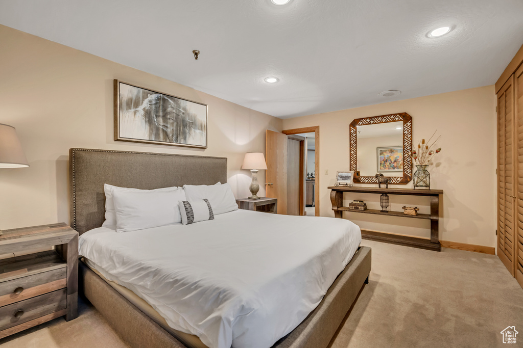 Bedroom with light carpet and recessed lighting