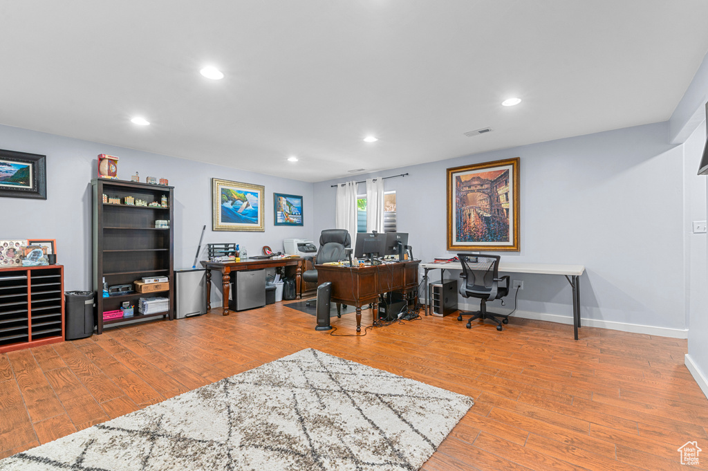 Office space with recessed lighting and wood finished floors
