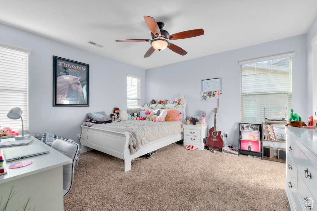 Bedroom featuring light carpet and a ceiling fan