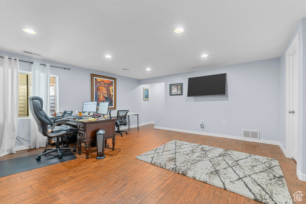Office featuring hardwood / wood-style flooring and recessed lighting