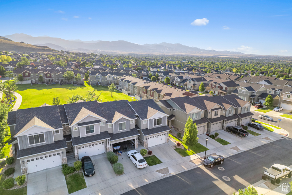 Aerial perspective of suburban area featuring a mountainous background