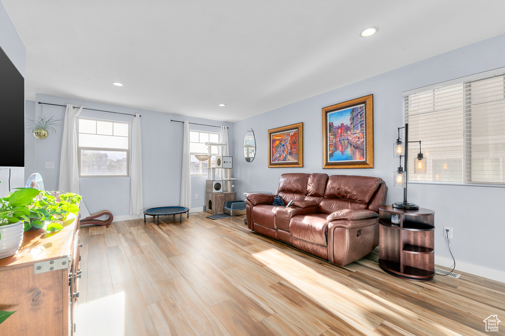 Living room featuring light wood-style floors and recessed lighting