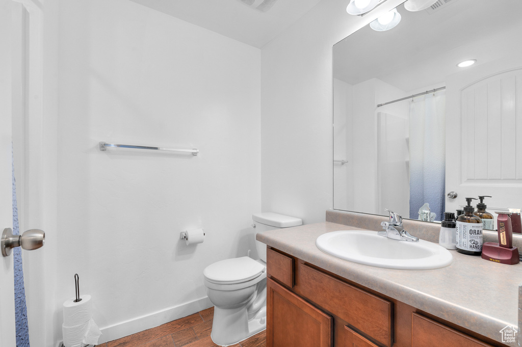Bathroom with vanity and wood finished floors