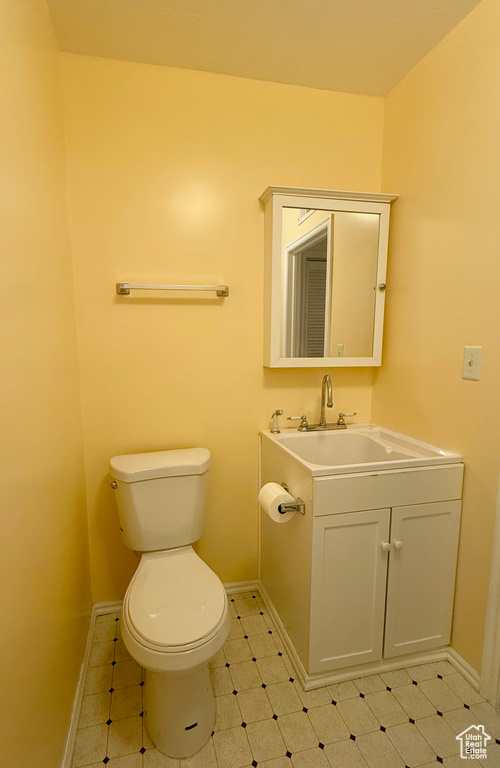 Half bath with vanity and tile patterned floors