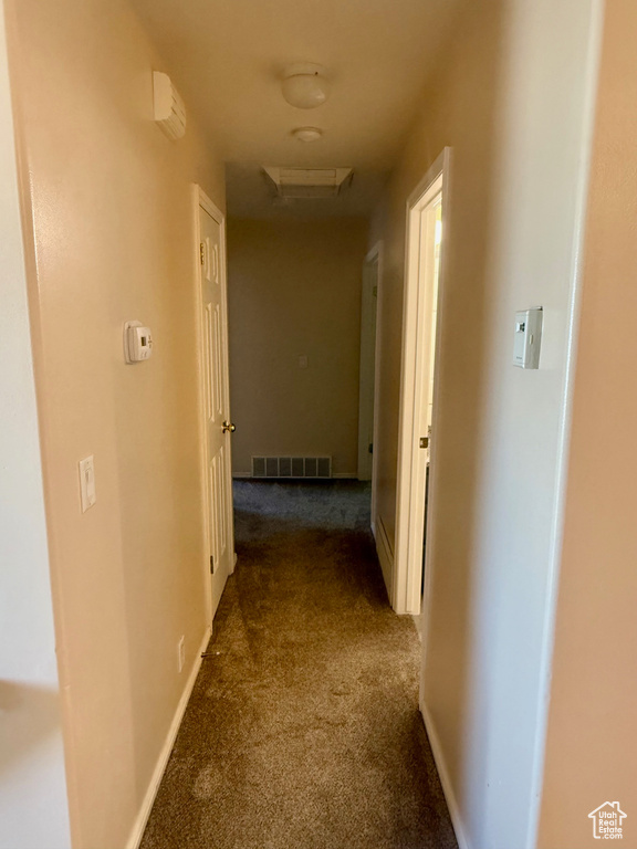 Hall featuring carpet floors and attic access