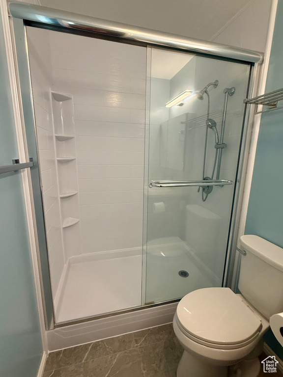 Full bathroom with a stall shower and marble look tiles