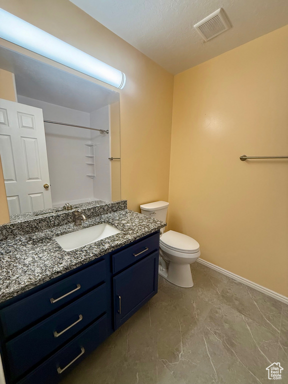 Full bath featuring vanity, a shower, and marble finish floors