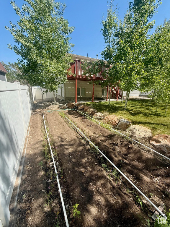 Fenced backyard with a deck and stairs