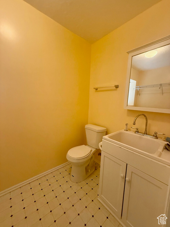 Half bathroom featuring vanity and tile patterned floors