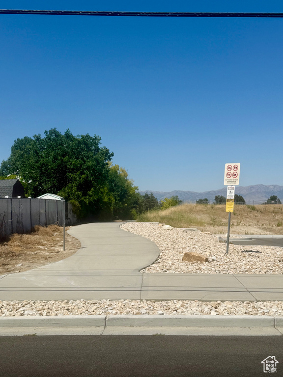 View of road featuring traffic signs and a mountain view