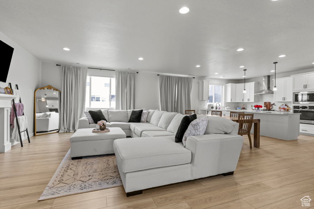 Living area featuring recessed lighting and light wood-type flooring