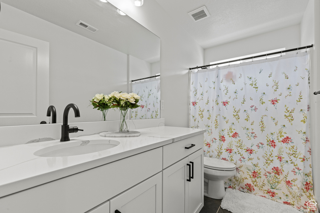 Bathroom featuring vanity and a shower with shower curtain
