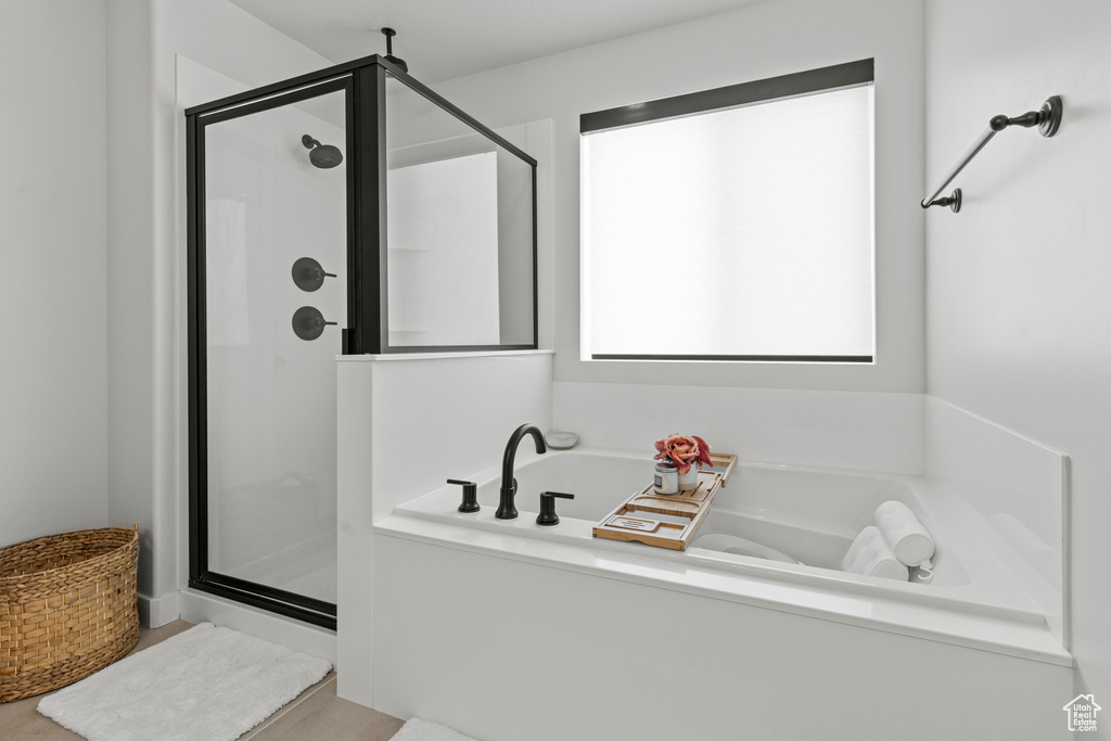 Full bathroom with a shower stall and a garden tub