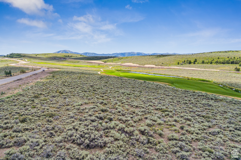 View of property's community with a mountain view and view of golf course