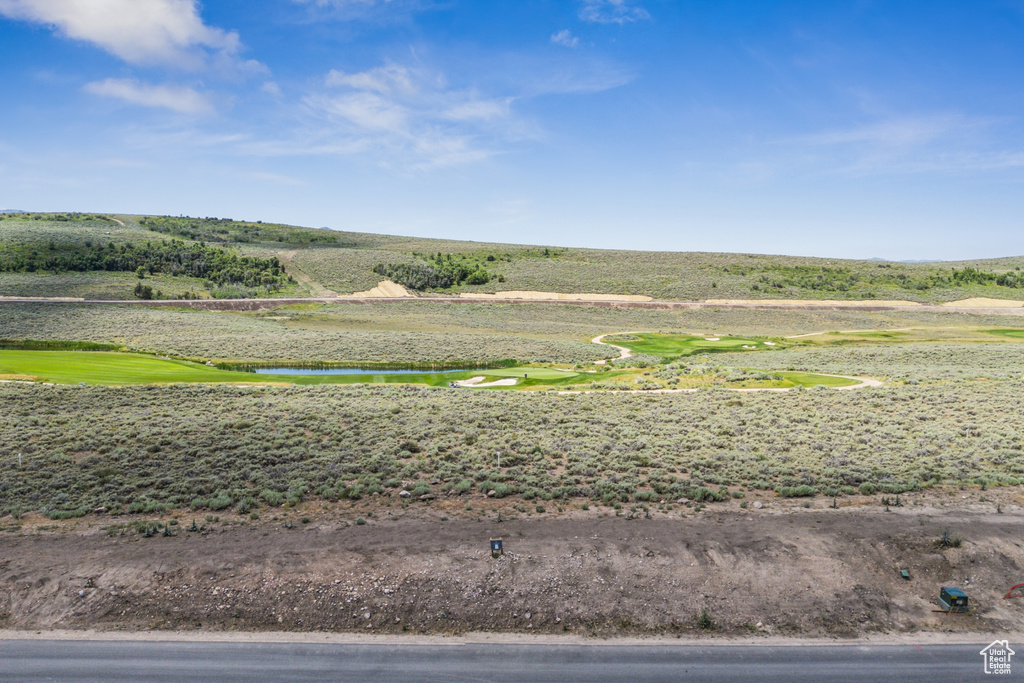 View of yard with a water view and view of golf course