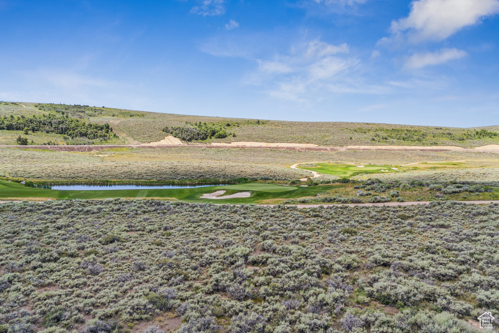 Surrounding community with a water view and golf course view