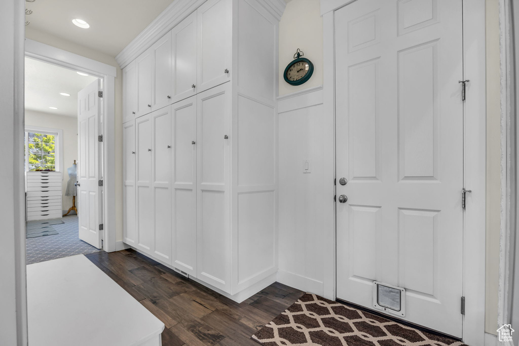 Entrance foyer with dark wood-style flooring and recessed lighting