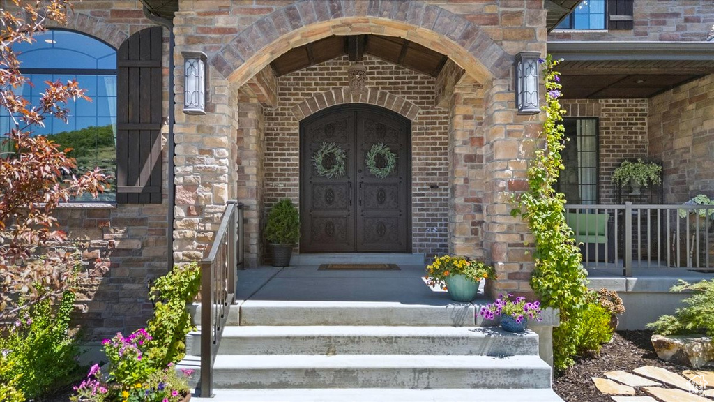 Property entrance featuring brick siding