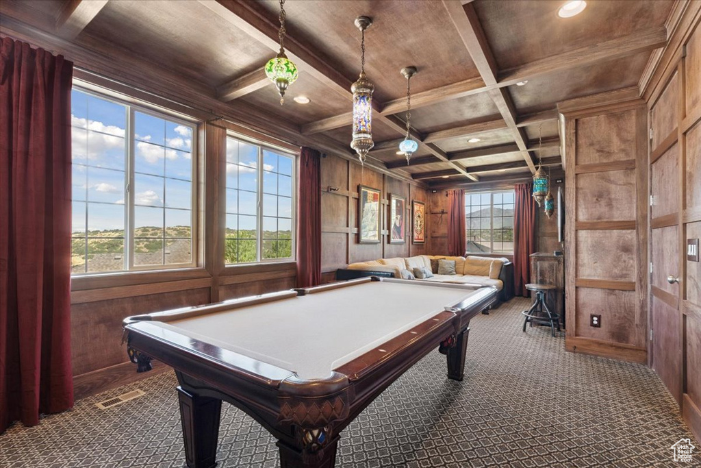 Rec room featuring dark carpet, wood walls, plenty of natural light, a wooden ceiling with exposed beams, and coffered ceiling