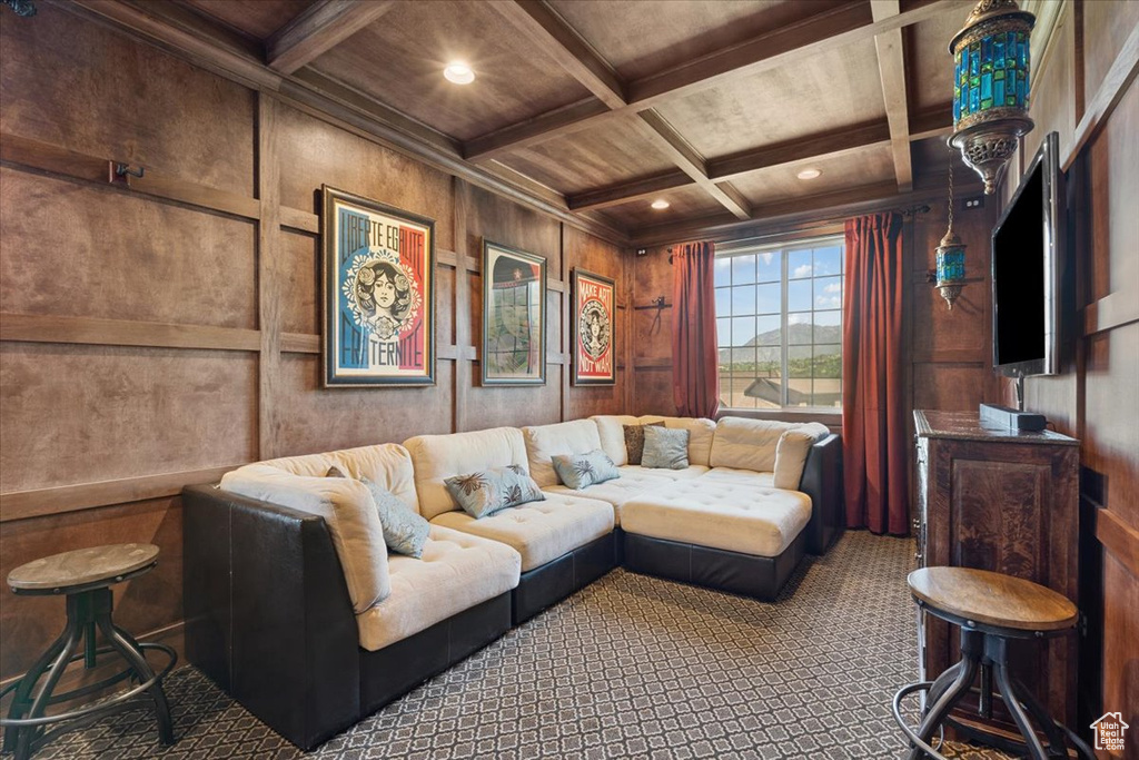 Carpeted living area with coffered ceiling, recessed lighting, a wood ceiling with exposed beams, and wood walls