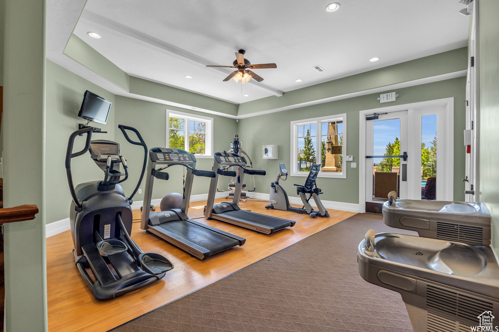 Workout area with ceiling fan, wood finished floors, and recessed lighting