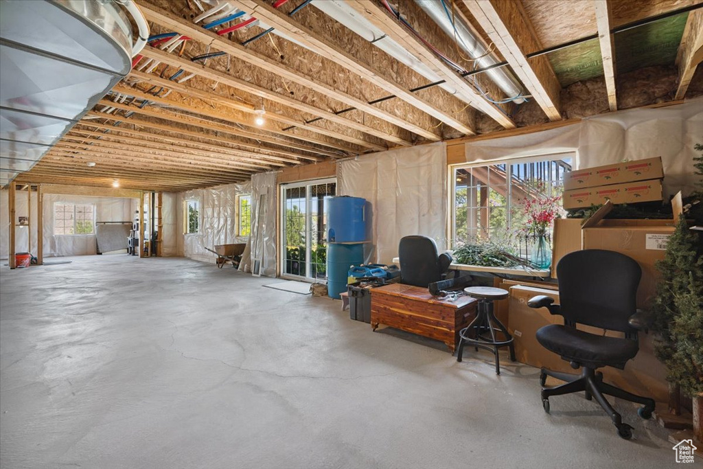Basement featuring plenty of natural light and a water pressure tank