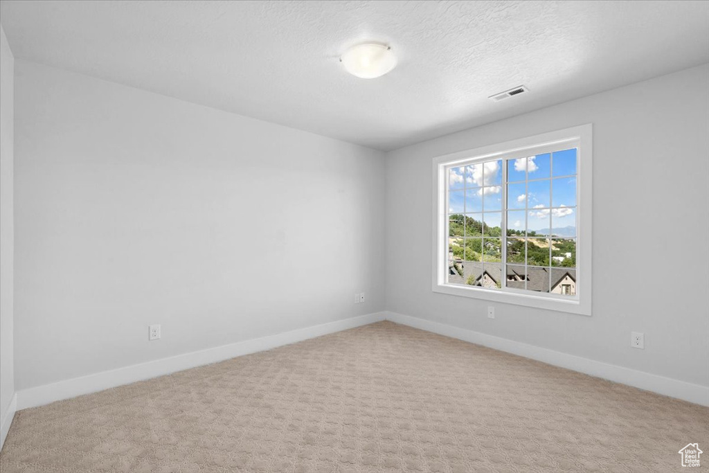 Spare room with baseboards and carpet floors