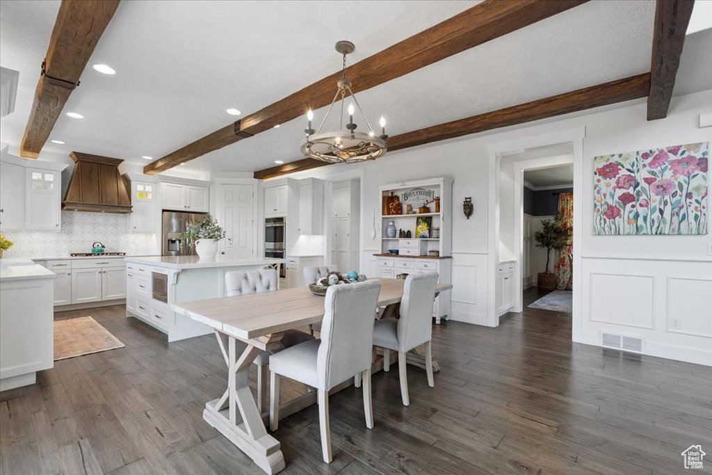 Dining room featuring beam ceiling, a chandelier, recessed lighting, and dark wood finished floors