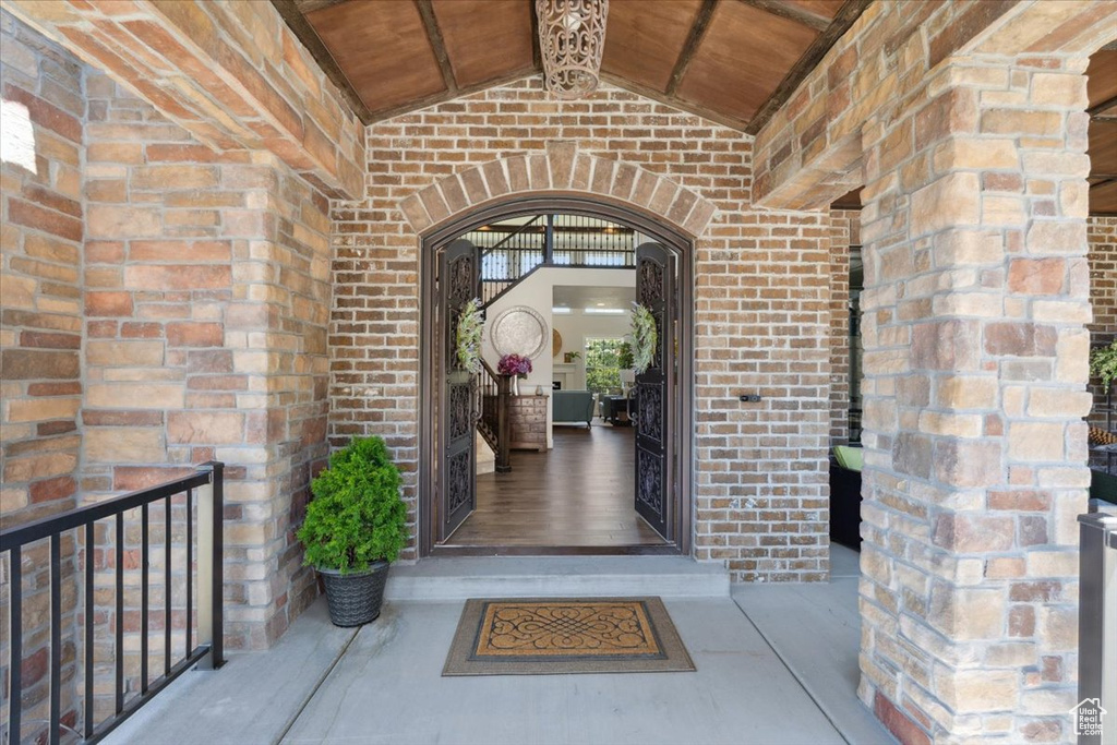 Doorway to property featuring brick siding