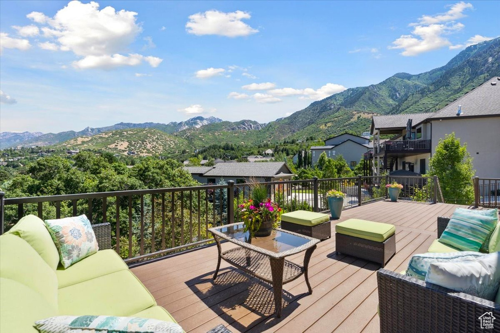 Wooden deck with an outdoor living space and a mountain view