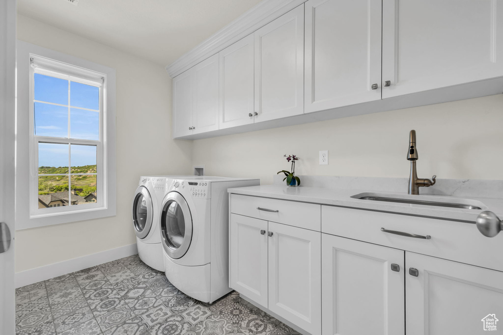 Washroom featuring cabinet space and independent washer and dryer